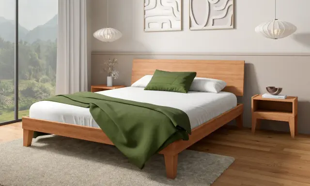 Acogedora habitación de 9m2 con cama de madera, manta verde y vistas a la montaña.