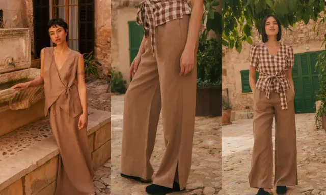 A woman models a chic beige linen pants outfit, showcasing a flowy wrap top and wide-leg trousers with stylish side slits.