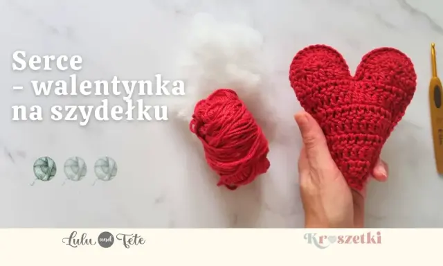 Czerwone serce na szydełku, gotowe na walentynki. Obok kłębek czerwonej włóczki i białe wypełnienie.