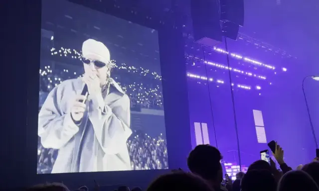 Sobel na ekranie, tłum z telefonami tworzy fiołkowe pole świateł. Koncert w fioletowej poświacie.