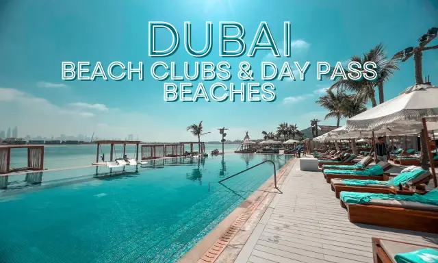 Piscina a sfioro e lettini prendisole in un lussuoso beach club di Dubai, con palme e vista sullo skyline.