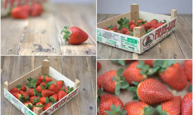 Cajas de madera con pintadas cajas de fresas decoradas, listas para ser disfrutadas. Frescura y sabor en cada detalle.