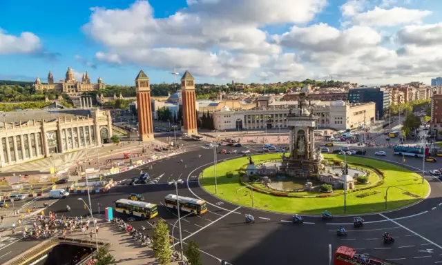 Widok na plac z fontanną i wieżami, idealny na weekend w Barcelona.
