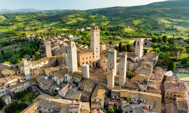 Aerial view of San Gimignano, Italy, with its medieval towers and Tuscan countryside.