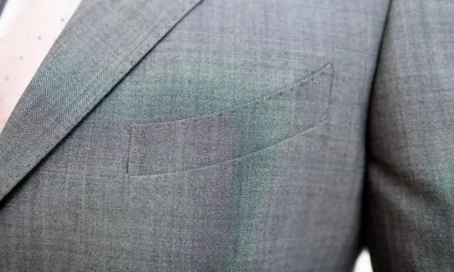 A suit jacket's breast pocket is sewn shut. This is often done to maintain the jacket's crisp silhouette, as why are pockets sewn shut is a common question for new suit owners.