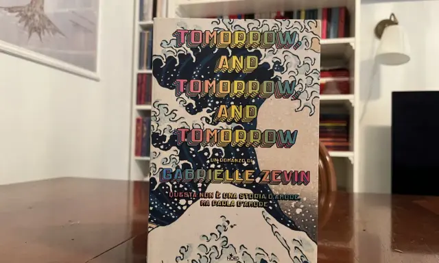 Copertina del libro "Tomorrow, and tomorrow, and tomorrow" di Gabrielle Zevin, con onde stilizzate e testo ripetuto.