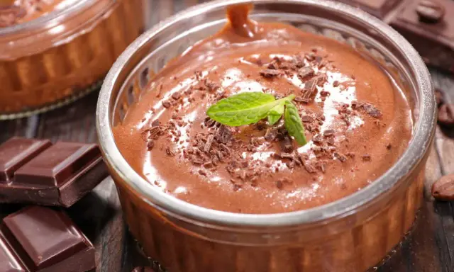 Mousse au chocolat Marie Morin recette : un délice onctueux, garni de copeaux de chocolat et d'une feuille de menthe, prêt à être dégusté.