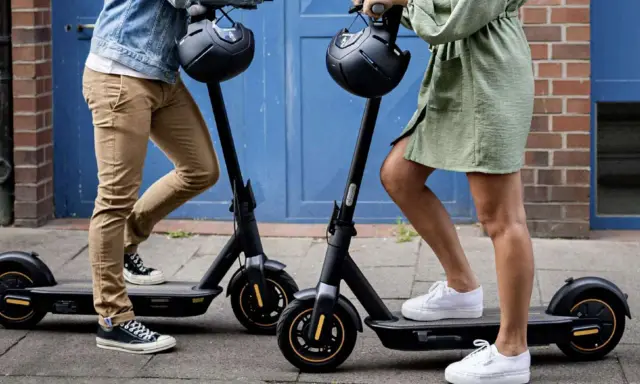 Apprenez comment utiliser une trottinette électrique pour vos déplacements urbains. Deux personnes se tiennent prêtes à partir.