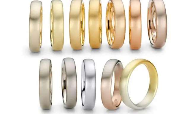 Collezione di fedi nuziali in oro giallo, oro rosso e oro rosa, con diverse finiture opache e lucide.