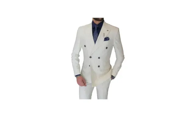 A man models a sharp double-breasted suit in white with subtle pinstripes. He wears a navy shirt and patterned tie, completing the sophisticated look.