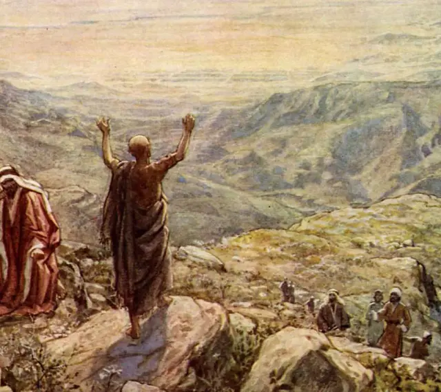 Balaam in the Bible, with arms raised, blesses Israel from a mountaintop. Another man in red looks on.