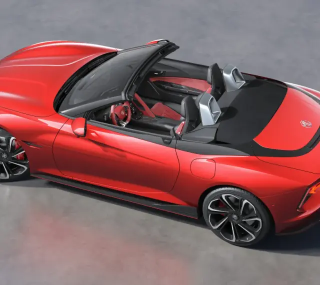 Czerwony MG Roadster z otwartym dachem, sportowe wnętrze, nowoczesne felgi i aerodynamiczne linie.