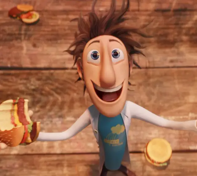 Flint Lockwood trzyma nadgryzionego hamburgera, podczas gdy wokół niego spadają klopsiki i inne zjawiska pogodowe.