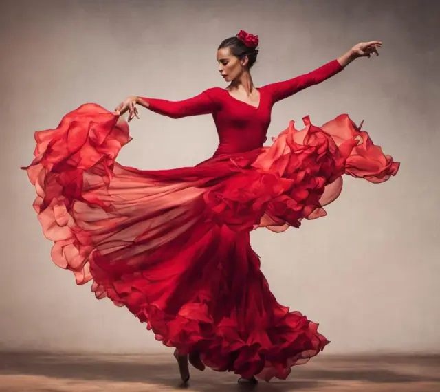 Tancerka w czerwonej sukni wiruje w rytm flamenco, jej strój faluje niczym płomienie.