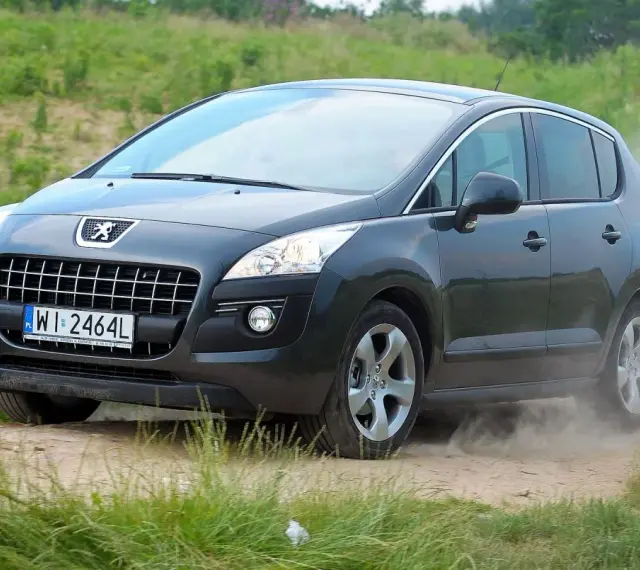 Szary Peugeot 3008 na drodze gruntowej, wzbijający kurz. Wiele osób szuka takich zdjęć, czytając peugeot 3008 opinie forum.