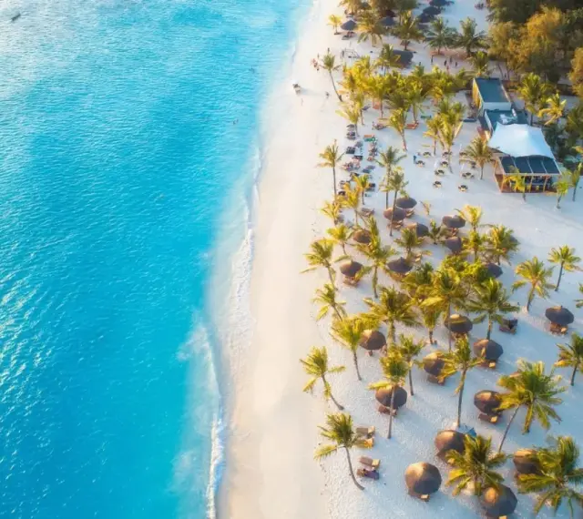 Rajska plaża na Zanzibarze, idealna na wakacje w październiku. Turkusowa woda, biały piasek i palmy tworzą idylliczny krajobraz.