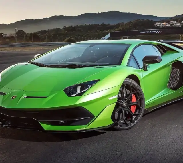 Jaskrawozielony Lamborghini Aventador SVJ na torze wyścigowym, gotowy do szaleństwa.