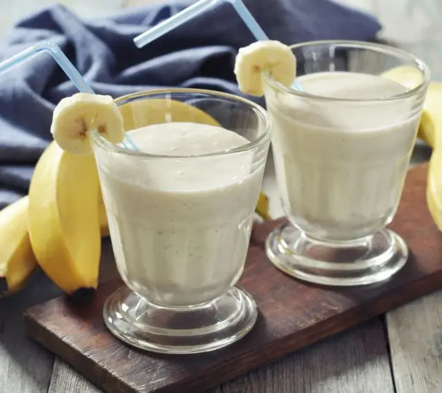 Dwa pyszne szejki proteinowe z bananem, gotowe do wypicia. Idealne po treningu!