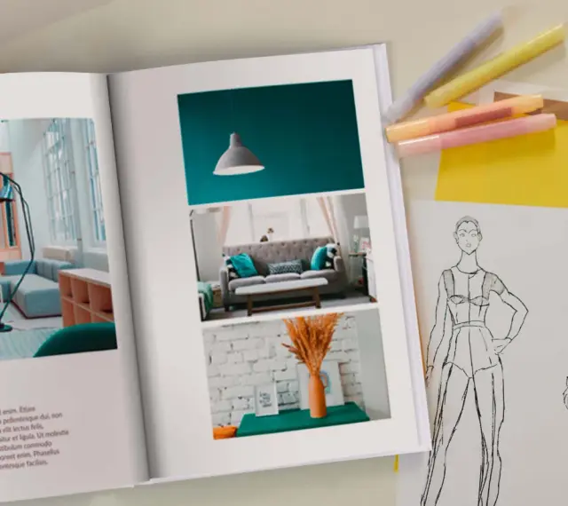 Otwarta księga prezentuje inspiracje do wzornictwa studia: projekt wnętrza i szkice modowe.