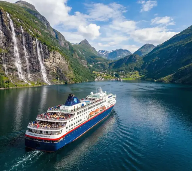 Statek wycieczkowy "Norwegian Fjord Explorer" płynie przez malowniczy fiord. To idealny sposób, by zobaczyć, co można przewieźć do Norwegii – zapierające dech w piersiach krajobrazy!