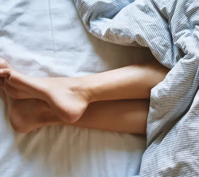 Nogi pod pościelą. Zastanawiasz się, jak często zmieniać piżamę? Czysta pościel to podstawa.