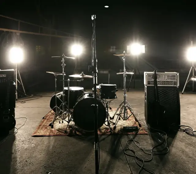 Scena z perkusją i wzmacniaczami, gotowa na koncert unplugged. Co to znaczy? To muzyka bez prądu, czysta energia!