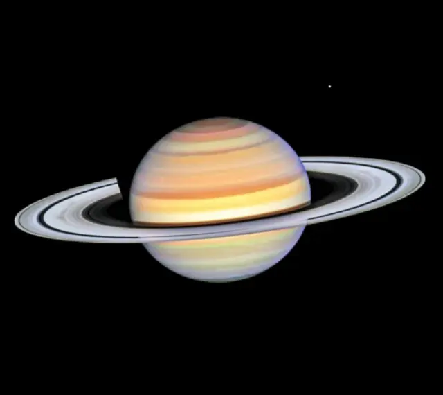 Saturn w Byku, majestatyczny gazowy olbrzym z pierścieniami, unoszący się w kosmicznej pustce.