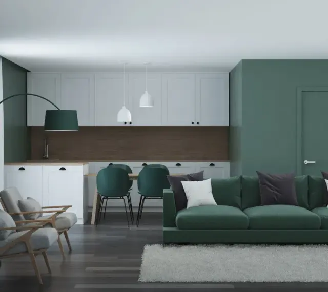 Nowoczesny salon z kuchnią w odcieniach zieleni. Seledynowy kolor ścian i mebli tworzy spokojną atmosferę.