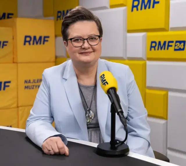 Minister edukacji w jasnej marynarce przed mikrofonem RMF FM.