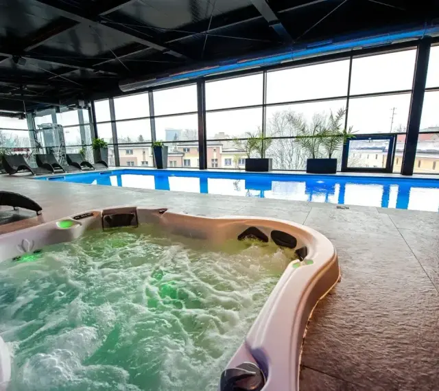 Relaks w hotelowym spa w Białymstoku: jacuzzi z bąbelkami i basen z widokiem na miasto.