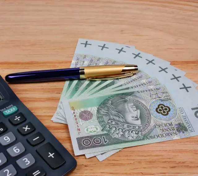 Kalkulator, długopis i banknoty 100 zł. Szukasz, który bank ma najwyższe oprocentowanie lokat na 3 miesiące?