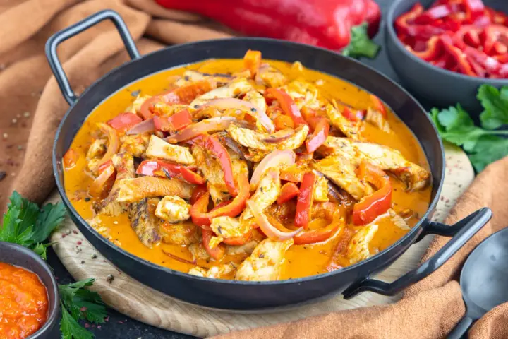 Ein einfaches Putengeschnetzeltes-Rezept mit Paprika und Zwiebeln in cremiger Sauce, serviert in einer Pfanne.