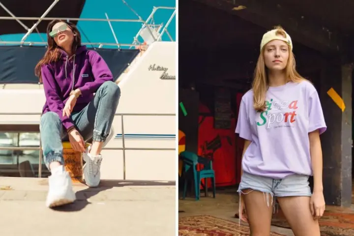 Dwie kobiety w modnych stylizacjach streetwear. Jedna w fioletowej bluzie i jeansach, druga w liliowej koszulce z napisem "Pizza Sport". Polskie marki odzieżowe streetwear w akcji.