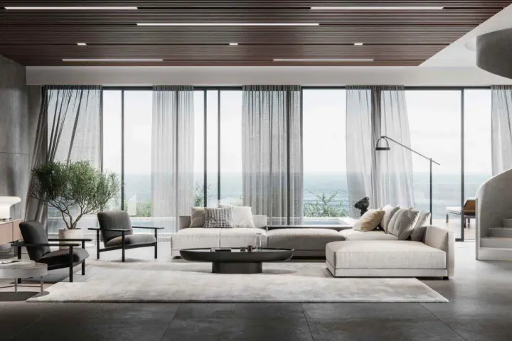 Soggiorno moderno con divano componibile, poltrone, tavolino e vista mare. L'arredamento evoca l'eleganza delle case stile americano, con linee pulite e materiali pregiati.
