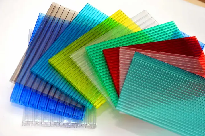 Sheets of colorful, ribbed polycarbonate, showcasing their versatility and potential for polycarbonate sustainability in various applications.