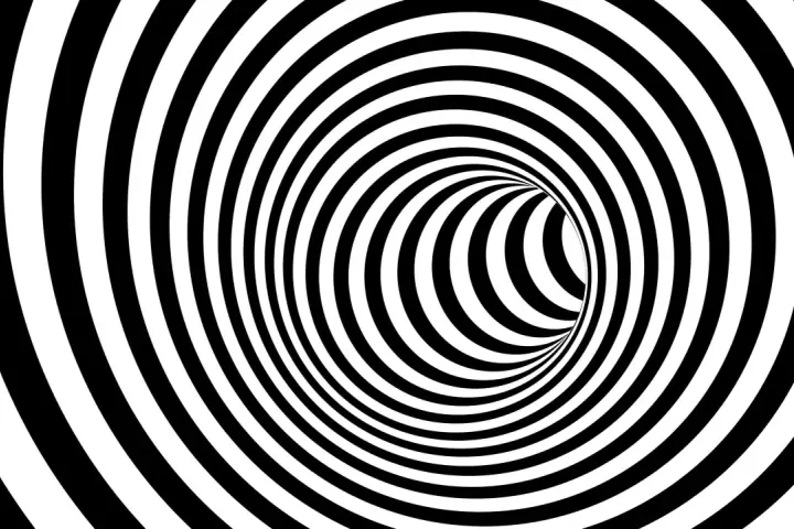En svartvit tunnel med spiralmönster som kan ge känslan av ångest tankar.