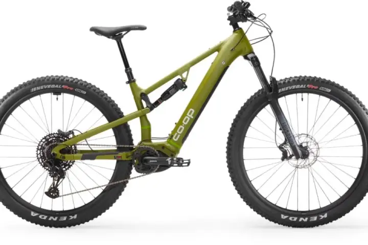 A green Co-op electric mountain bike, ready for a REI bike tune-up, with full suspension and knobby tires.