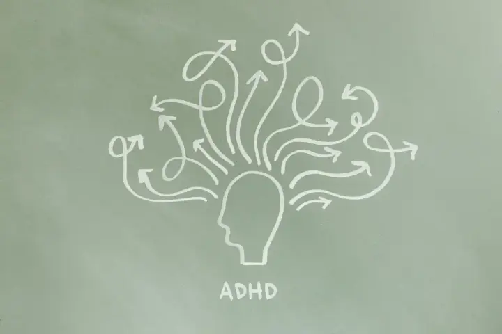 Grafika przedstawia głowę z mnóstwem strzałek wychodzących z niej we wszystkich kierunkach, symbolizującą ADHD.