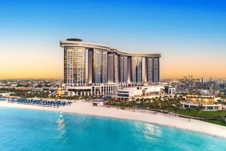 Luksusowy Rixos Premium Alamein z widokiem na turkusowe morze i piaszczystą plażę. Idealne miejsce na wakacje.