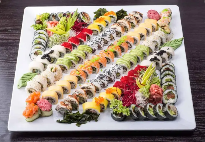 Ogromna taca sushi z różnymi rolkami, idealna do wyboru z menu Mizumi Sushi. Kolorowe składniki i estetyczne ułożenie.