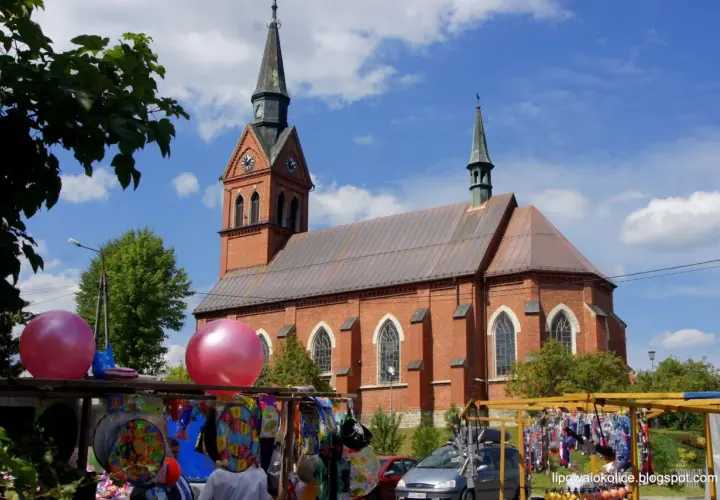 Jarmark z balonami i kościołem w tle. Może to przygotowania do imienin Bartłomieja?