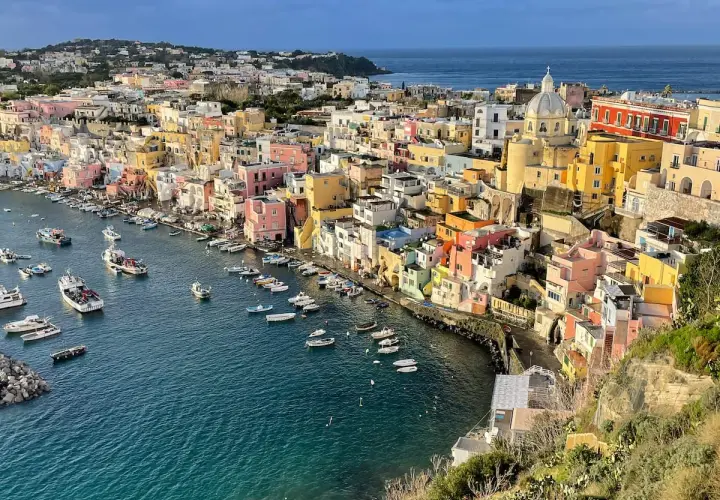 Colorful houses line a harbor filled with boats, a picturesque scene of things to do in Procida.