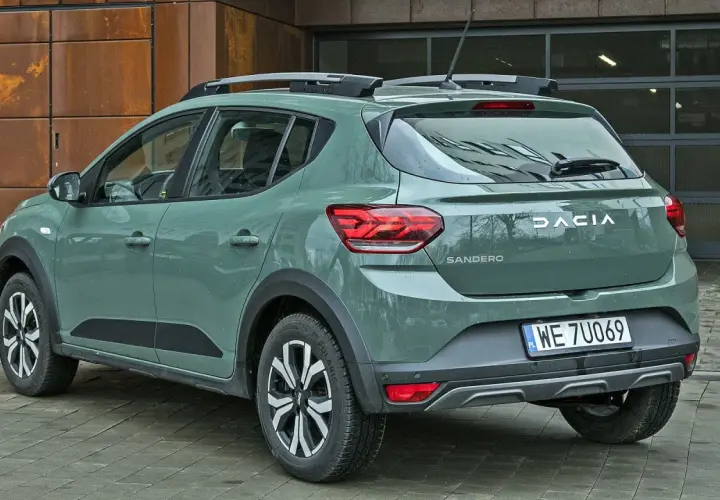 Dacia Sandero w zielonym kolorze lakieru, z relingami dachowymi, prezentuje się nowocześnie.