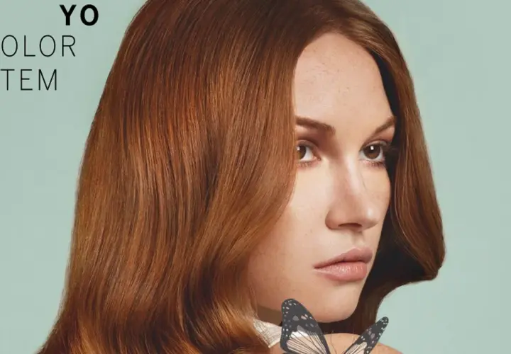 Kobieta z rudymi włosami i motylem na ramieniu, tekst "YO COLOR SYSTEM".