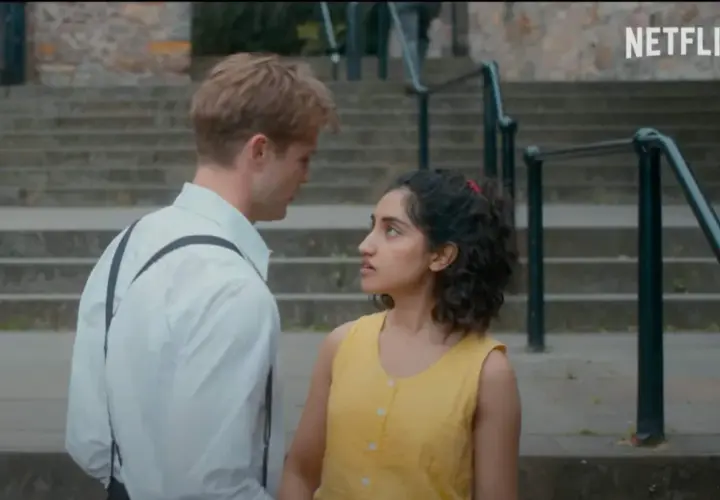 Un ragazzo e una ragazza si guardano intensamente su una scalinata. Le loro espressioni suggeriscono un momento carico di emozioni, forse l'inizio di una storia che troverà spazio nelle recensioni di un giorno.