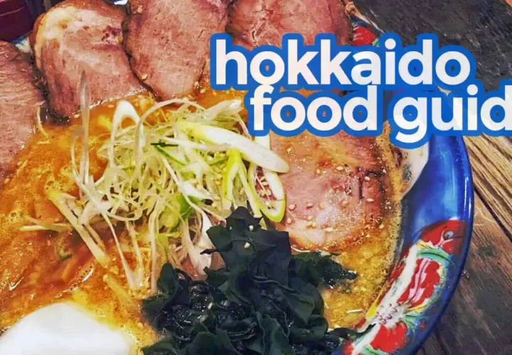 A steaming bowl of ramen, a quintessential Hokkaido food, features tender chashu pork, green onions, and seaweed in a rich broth.