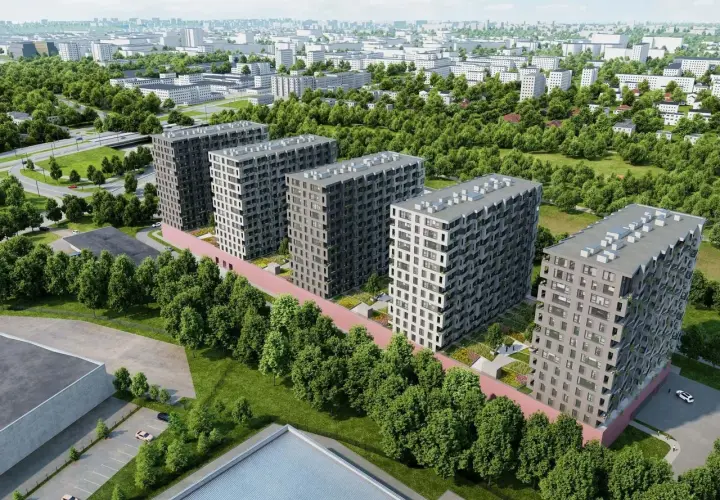 Nowoczesne bloki mieszkalne otoczone zielenią, z widokiem na miasto pod **tuwima sky**.