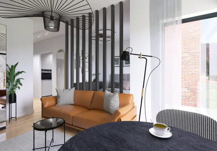 Nowoczesny salon z brązową kanapą i stolikami. W tle kuchnia i sypialnia. Projekt rafin developer.