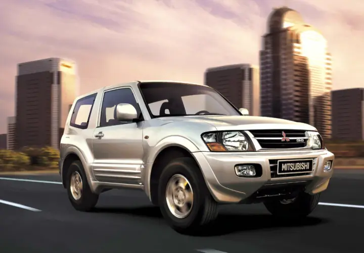 Silver Mitsubishi Montero 3.2 DID en movimiento, con edificios modernos de fondo. A pesar de su robustez, algunos propietarios han reportado problemas.