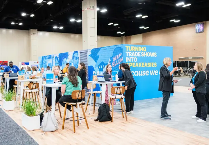 Attendees network at government trade shows, with a vibrant blue booth promoting "Turning Trade Shows Into Speakeasies.